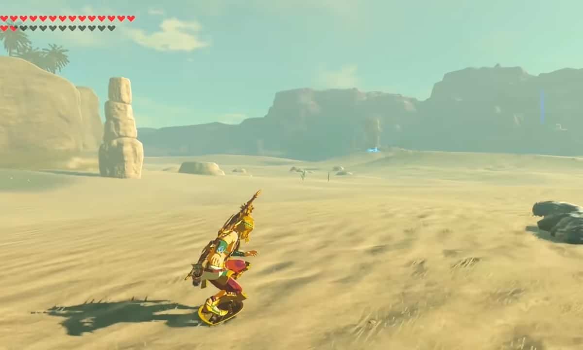 Tears of the Kingdom how to shield surf: Link shield surfing through a desert.