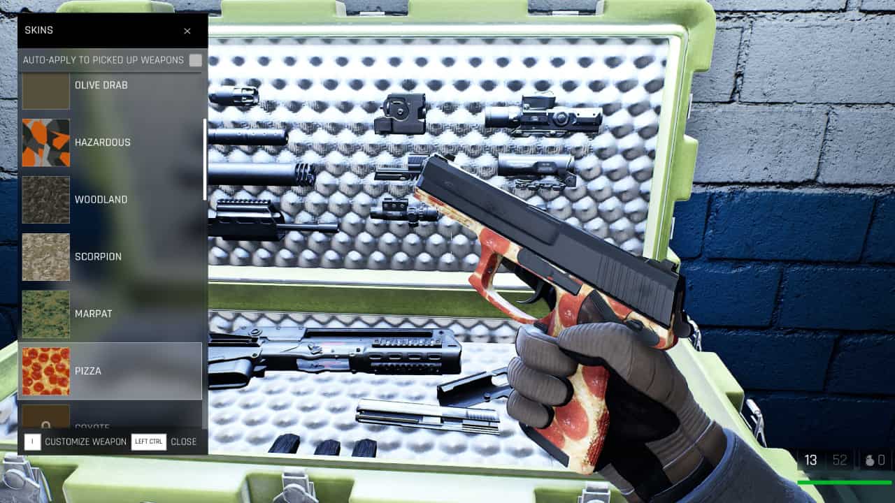 Trepang2 how to customise appearance: Subject 106 equips a pizza themed weapon skin to his pistol at the workbench crate in the safe house.