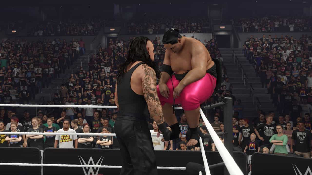 How to break the ring in WWE 2K24 - two wrestlers at the edge of the ring.