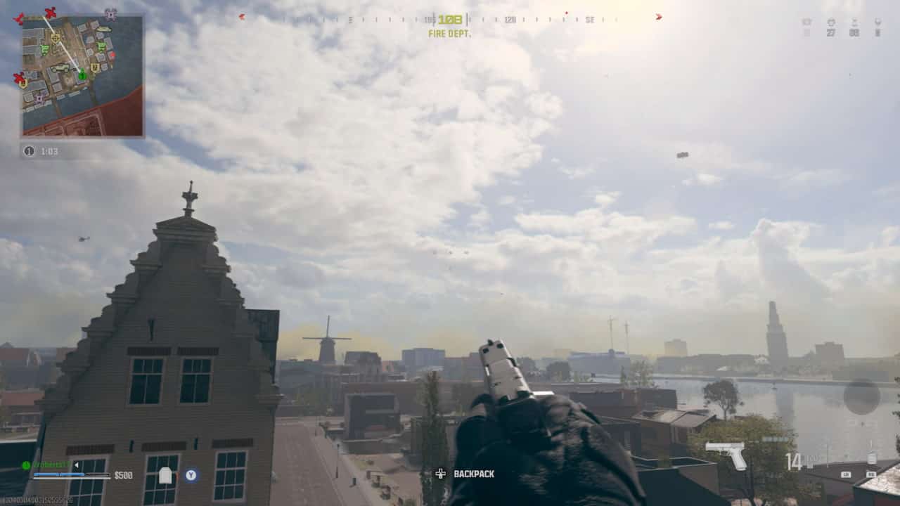 First-person perspective of a player holding a pistol in a virtual environment with an urban landscape and hazy sky, exploring gameplay options for the Call of Duty battle royale.