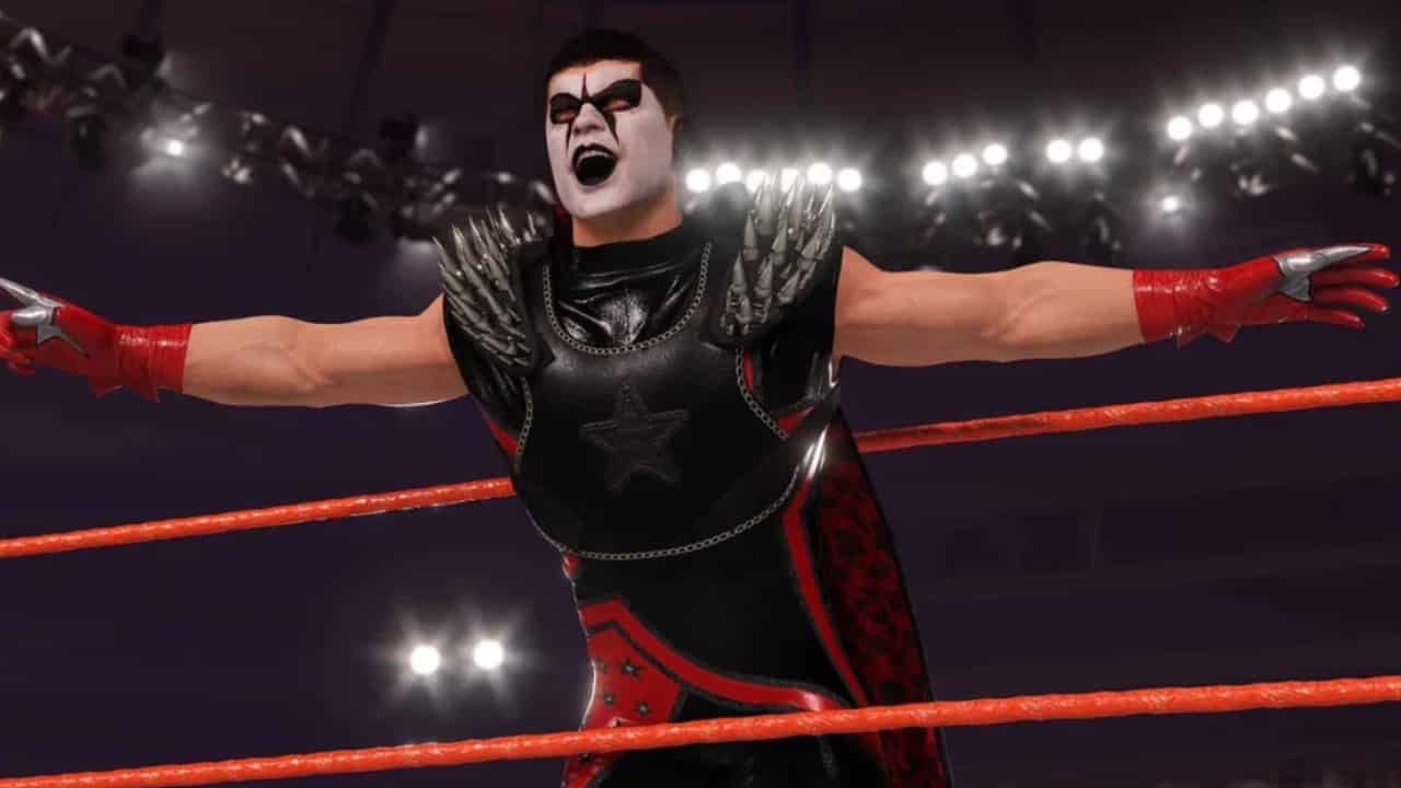 WWE 2K24 Stardust - A wrestler in a wrestling ring with his hands up.