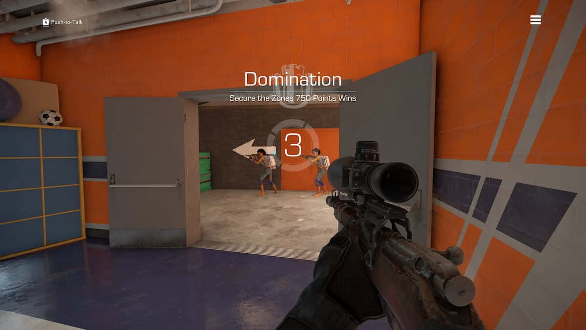 First-person shooter game screenshot from XDefiant showing players in a bright orange and blue room, with “Domination” game mode and “3” second countdown displayed on screen. Two players are visible in front.