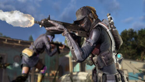 XDefiant player firing a weapon. The bullet trace is showing at the muzzle of the gun. A player running is in the background.